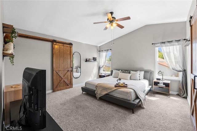 bedroom featuring carpet flooring, multiple windows, a barn door, and lofted ceiling