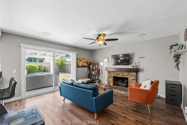 27884 Beacon St, Castaic, CA 91384 - living room featuring baseboards, a ceiling fan, a stone fireplace, and wood finished floors