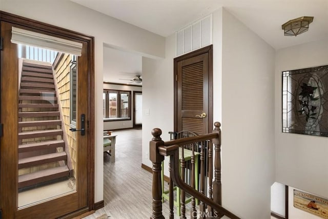 57 B Surfside Ave, Surfside, CA 90743 - hall featuring visible vents, wood finished floors, an upstairs landing, stairs, and baseboards