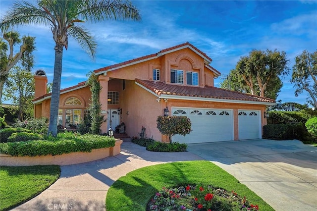 17816 Tuscan Dr, Granada Hills, CA 91344 - mediterranean / spanish home featuring stucco siding, a tiled roof, and concrete driveway