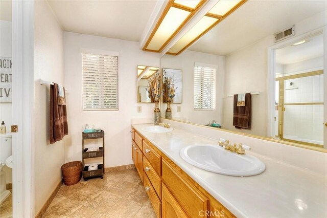 17816 Tuscan Dr, Granada Hills, CA 91344 - full bath with double vanity, a shower, baseboards, and toilet