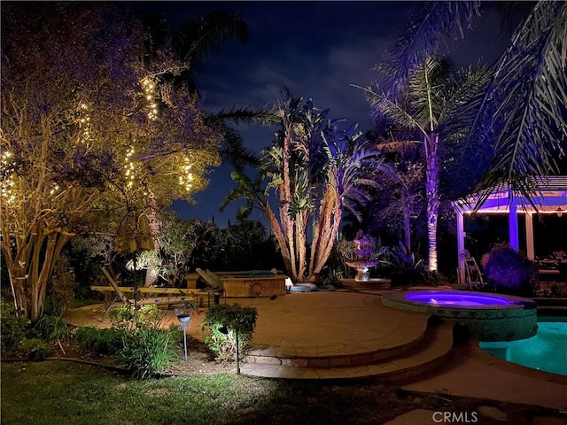 exterior space with a pool with connected hot tub