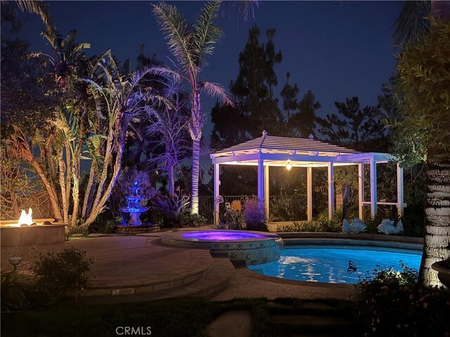 17816 Tuscan Dr, Granada Hills, CA 91344 - pool at night with an outdoor fire pit, a gazebo, and a pool with connected hot tub