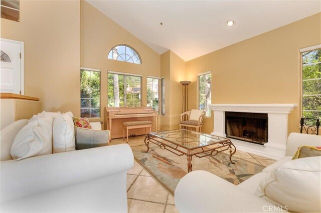 17816 Tuscan Dr, Granada Hills, CA 91344 - living area with light tile patterned floors, high vaulted ceiling, a fireplace with raised hearth, and recessed lighting