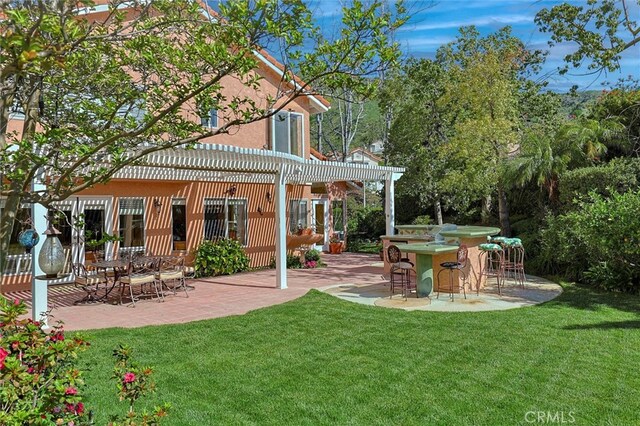 17816 Tuscan Dr, Granada Hills, CA 91344 - back of property featuring a patio area, a lawn, and a pergola
