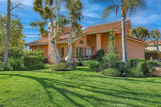17816 Tuscan Dr, Granada Hills, CA 91344 - back of house with stucco siding, a yard, and a tiled roof