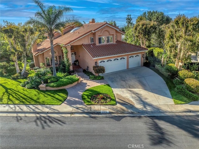 17816 Tuscan Dr, Granada Hills, CA 91344 - view of front of home with a tiled roof, stucco siding, an attached garage, and driveway