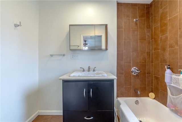 bathroom with vanity, ceiling fan, baseboards, shower / bathtub combination, and tile patterned flooring