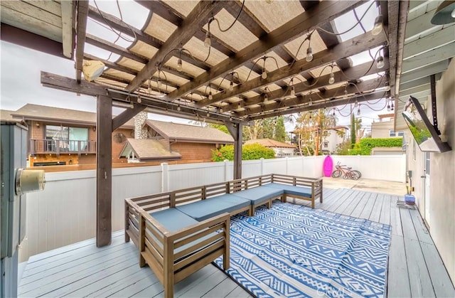 wooden terrace featuring an outdoor living space, a pergola, and a fenced backyard