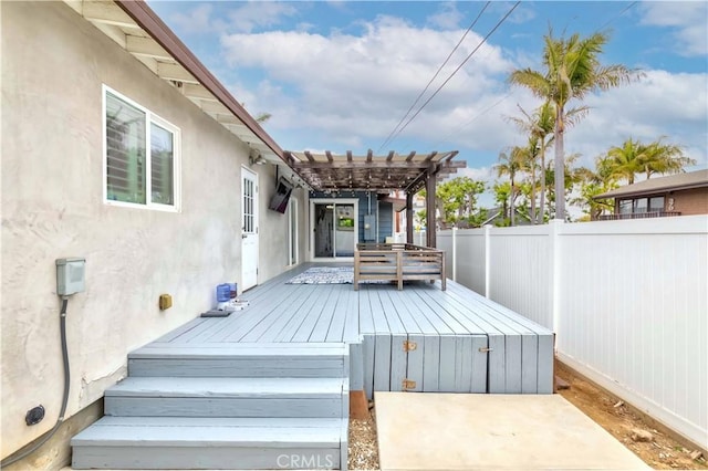 wooden deck featuring a pergola, fence private yard, and a patio area