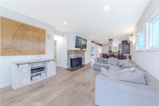 living area featuring recessed lighting, light wood-type flooring, a fireplace, and baseboards
