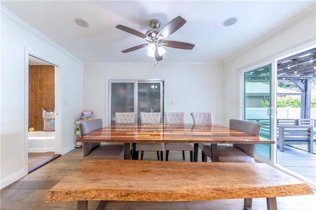 dining room with ceiling fan, baseboards, ornamental molding, and wood finished floors