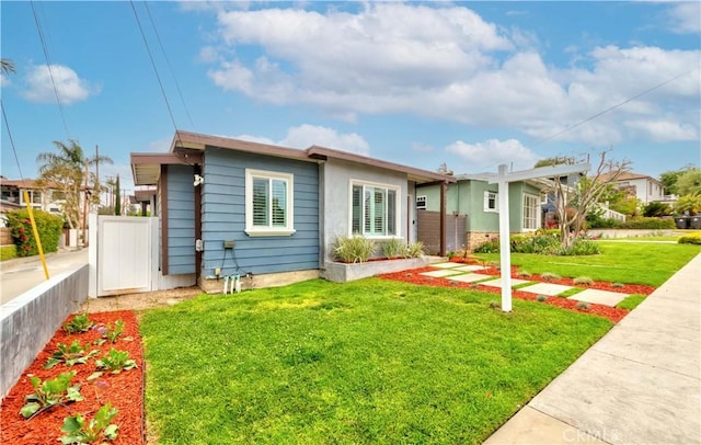 ranch-style home featuring fence and a front yard