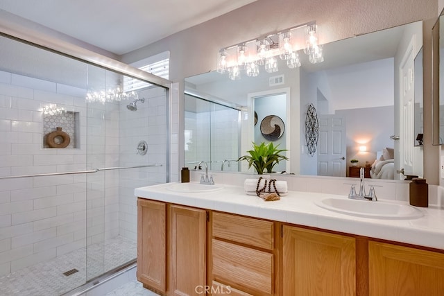 full bathroom with ensuite bath, a stall shower, double vanity, and a chandelier
