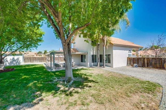 rear view of house featuring stucco siding, a pergola, and a patio area