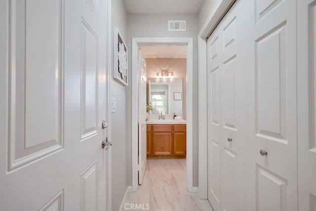 hall with light marble finish flooring and baseboards