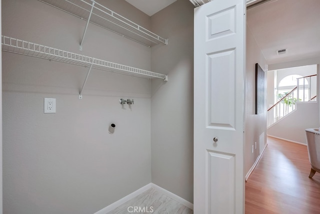 washroom featuring baseboards and light wood-style floors