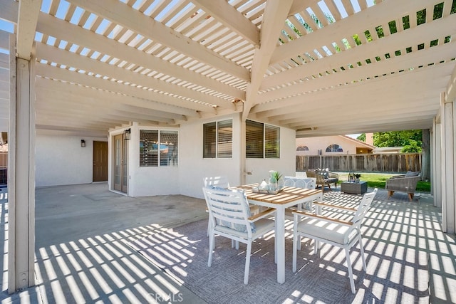 view of patio / terrace with fence, a pergola, and outdoor dining area