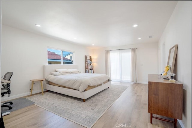 bedroom with light wood-type flooring, baseboards, and recessed lighting