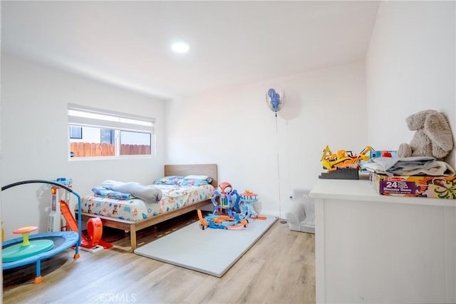 bedroom featuring wood finished floors, baseboards, and recessed lighting