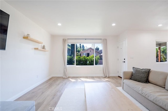 living room with light wood-type flooring, recessed lighting, and a wealth of natural light