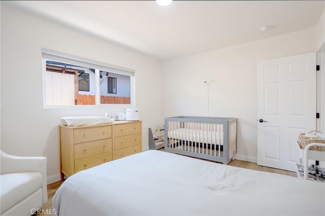 bedroom featuring baseboards and light wood-style floors