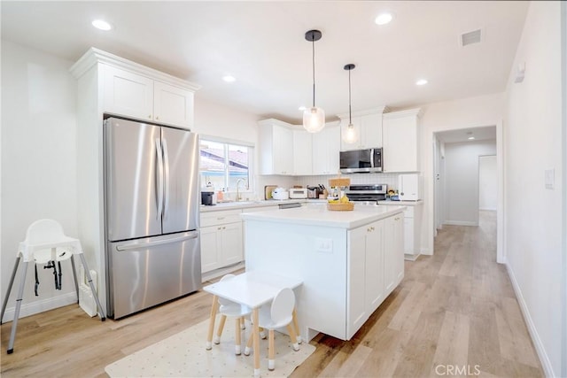 kitchen with white cabinets, appliances with stainless steel finishes, a sink, and visible vents