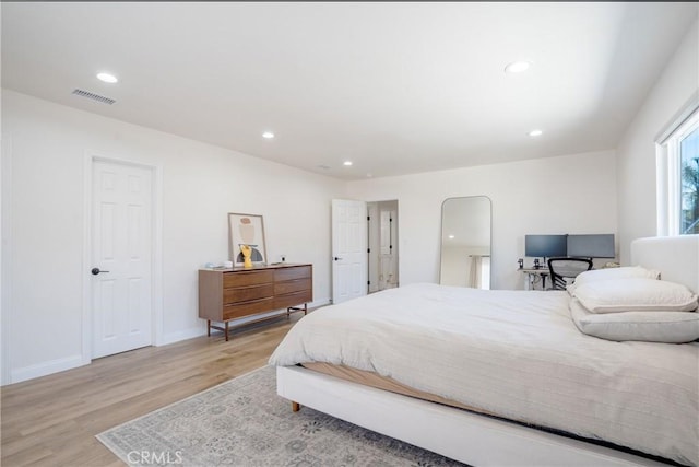 bedroom with light wood-style floors, baseboards, visible vents, and recessed lighting