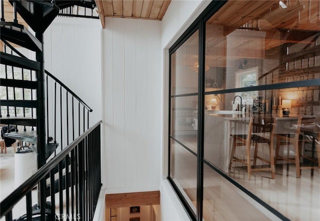 interior space featuring wood walls and wooden ceiling
