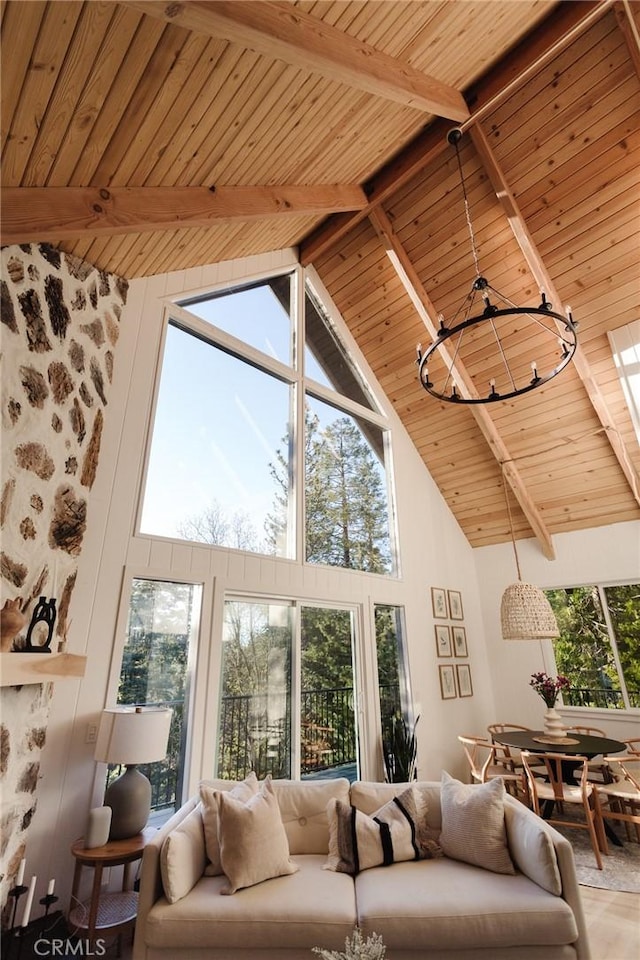 sunroom with a notable chandelier and beamed ceiling