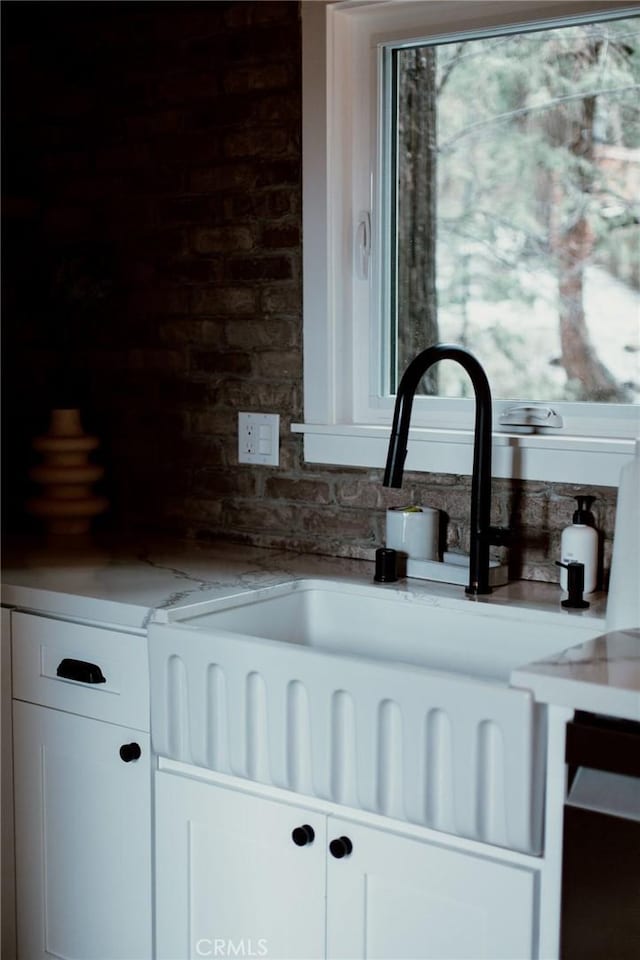 details featuring white cabinets and a sink