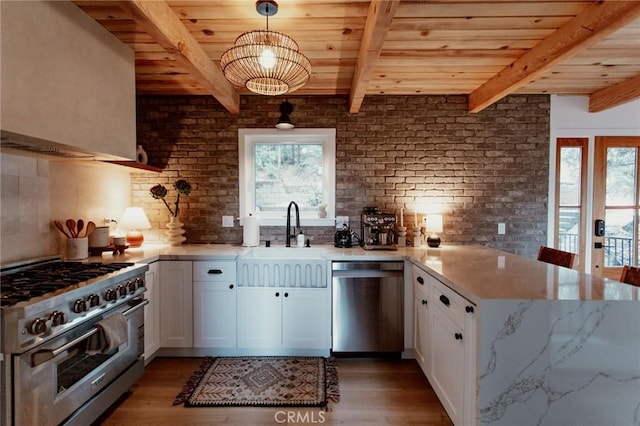 kitchen featuring a sink, appliances with stainless steel finishes, wooden ceiling, and a peninsula