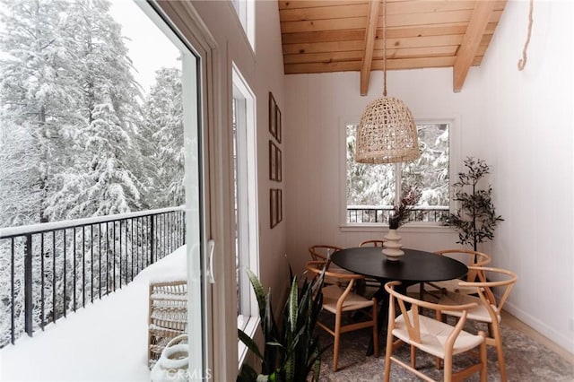 dining area featuring beam ceiling and wood ceiling