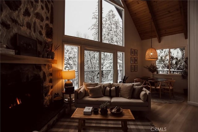 living room with wood finished floors, wooden ceiling, beam ceiling, a fireplace, and high vaulted ceiling