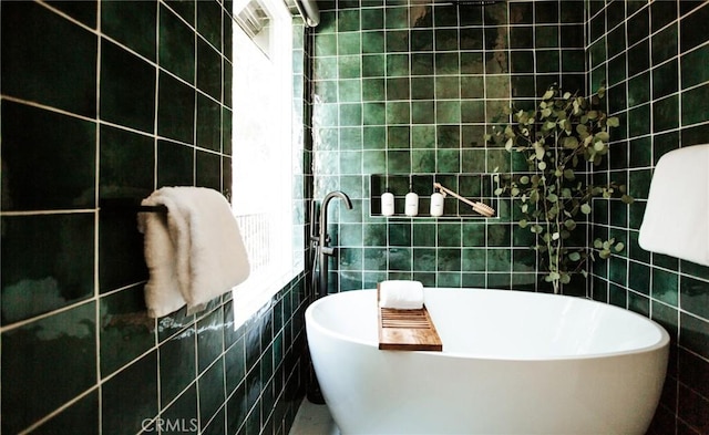 full bathroom featuring a soaking tub and tile walls