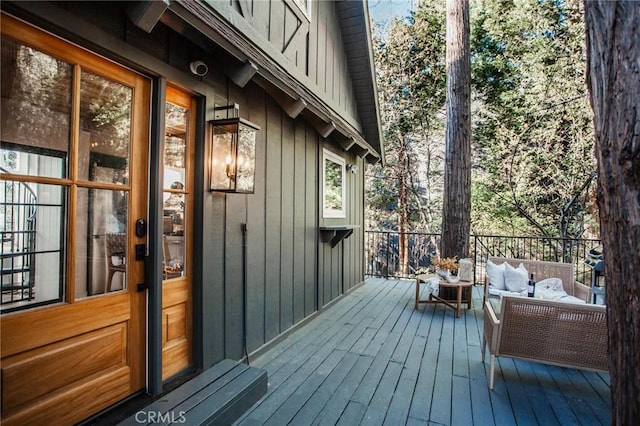 wooden deck with an outdoor living space