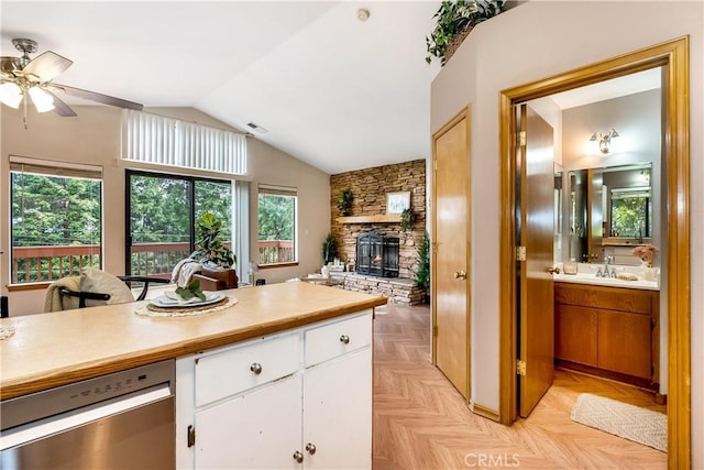 862 Strawberry Peak Rd, Twin Peaks, CA 92391 - kitchen featuring white cabinets, ceiling fan, a sink, a fireplace, and light countertops