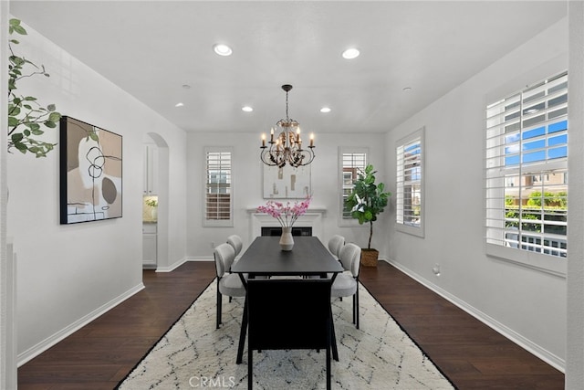 17245 Eagle Canyon Pl, San Diego, CA 92127 - dining space featuring baseboards, dark wood-type flooring, arched walkways, recessed lighting, and a chandelier