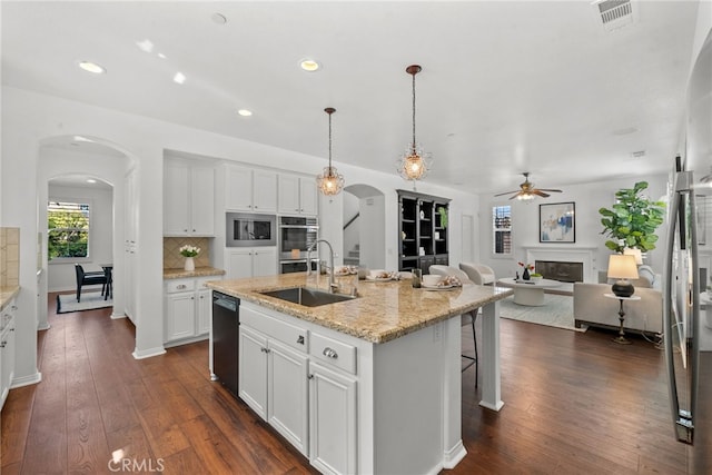 17245 Eagle Canyon Pl, San Diego, CA 92127 - kitchen featuring arched walkways, ceiling fan, a sink, appliances with stainless steel finishes, and white cabinetry