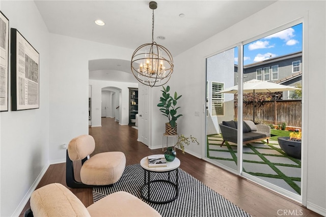 17245 Eagle Canyon Pl, San Diego, CA 92127 - living area with arched walkways, wood finished floors, a chandelier, recessed lighting, and baseboards