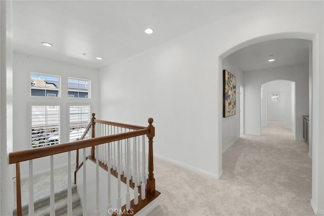 17245 Eagle Canyon Pl, San Diego, CA 92127 - hallway with arched walkways, an upstairs landing, carpet floors, recessed lighting, and baseboards