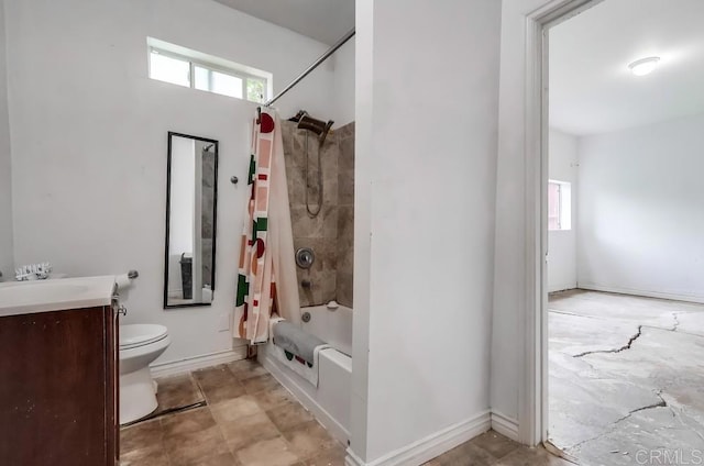 bathroom featuring toilet, vanity, shower / tub combo with curtain, and plenty of natural light