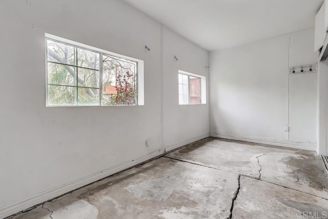 spare room with unfinished concrete floors