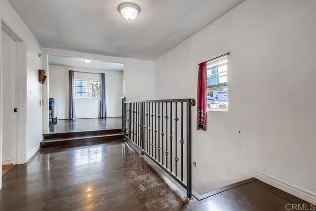 interior space with baseboards and wood finished floors