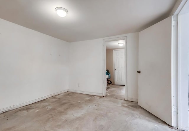empty room with concrete flooring
