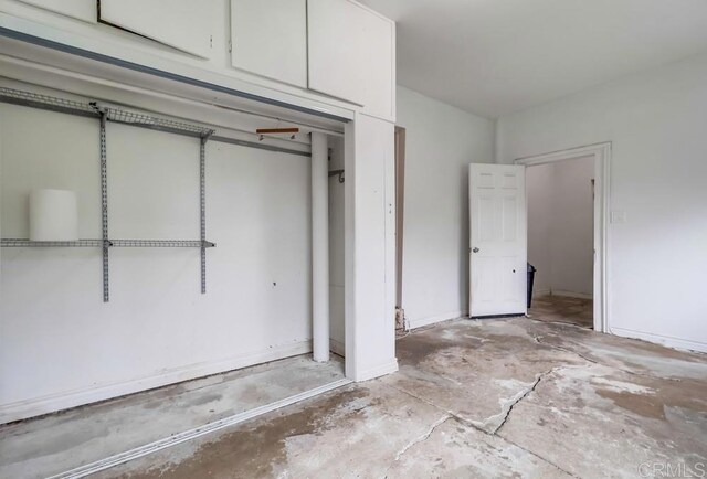 unfurnished bedroom featuring concrete flooring