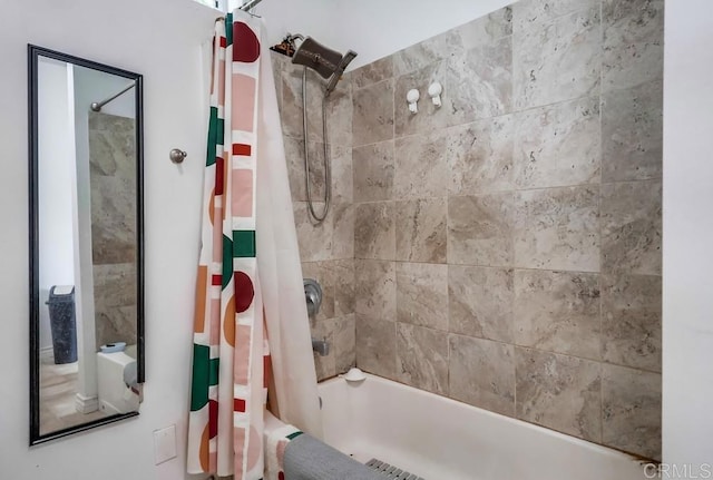 bathroom with shower / bath combo with shower curtain