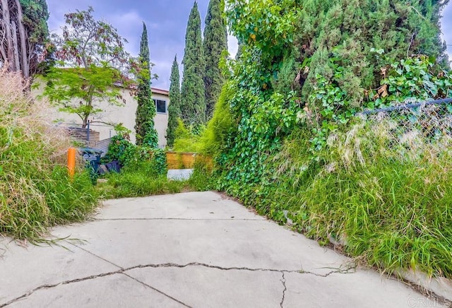 view of home's community with a patio and fence