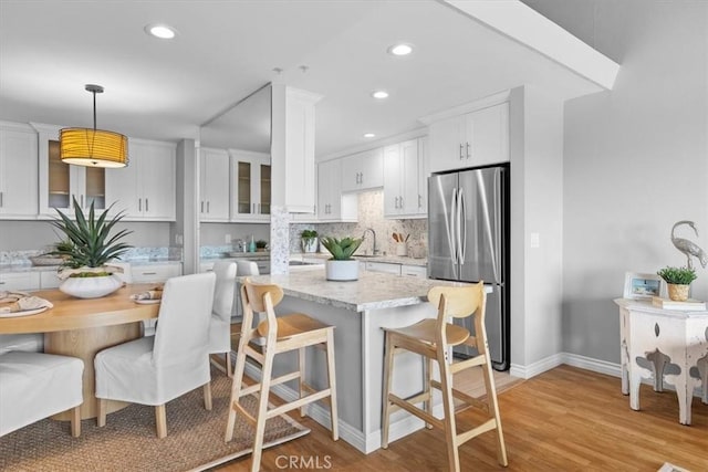 6542 Ocean Crest Dr Unit D308, Rancho Palos Verdes, CA 90275 - kitchen with freestanding refrigerator, light wood-type flooring, white cabinetry, baseboards, and recessed lighting