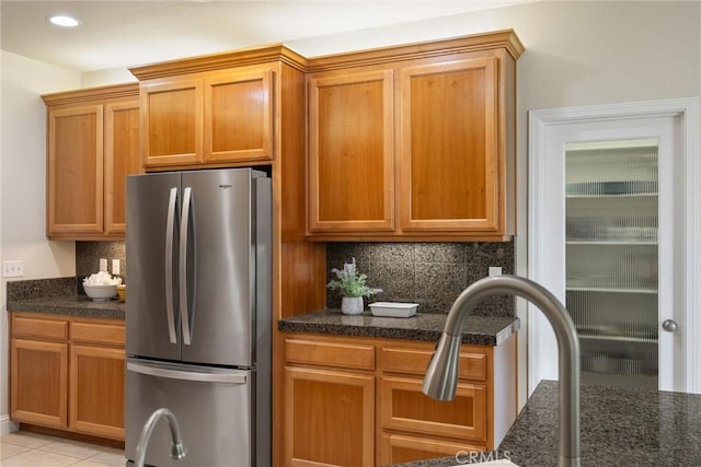2327 Via Calle Ct, Durham, CA 95938 - kitchen featuring brown cabinetry, backsplash, recessed lighting, and freestanding refrigerator